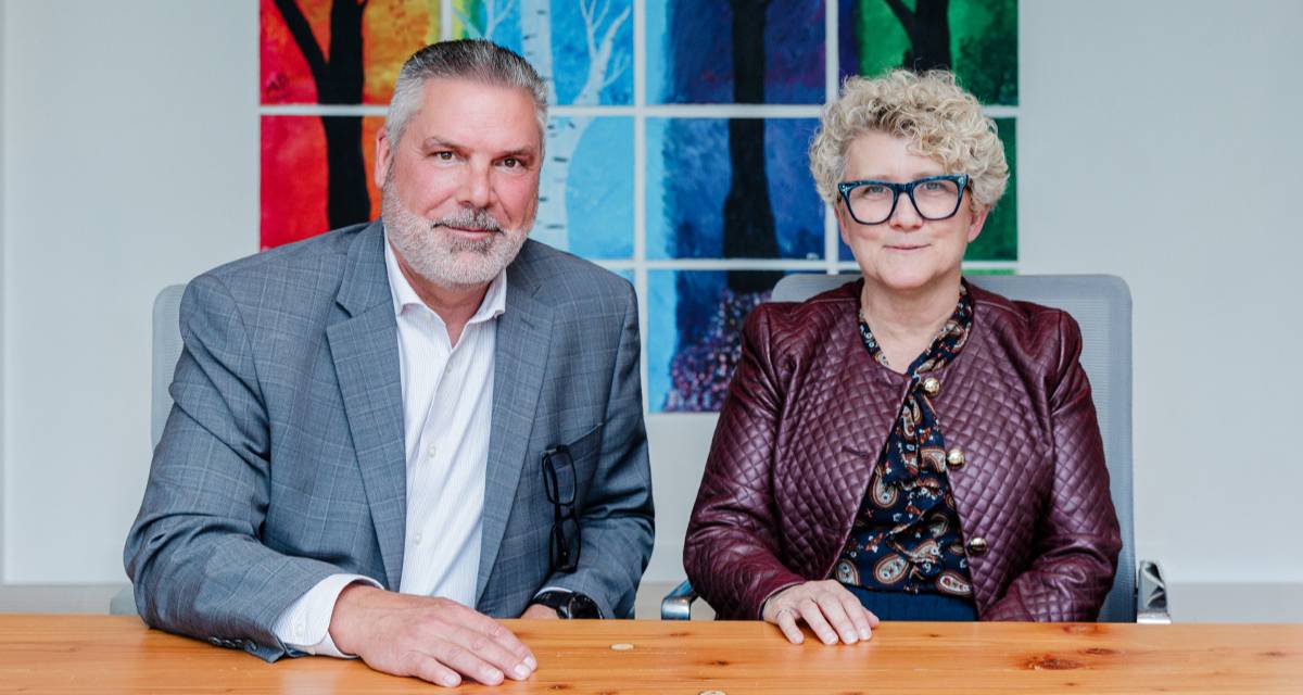 A man and a woman are seated at a table