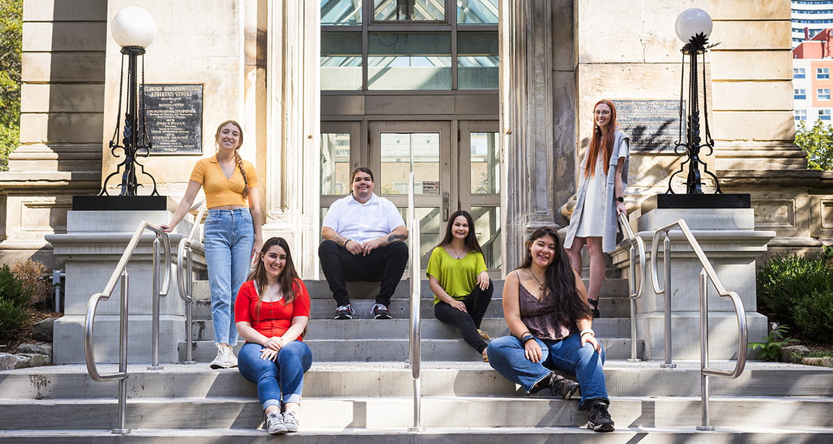 A group of students sitting on university steps