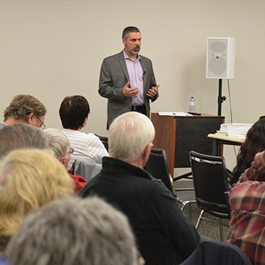 This image shows Derek Wilson presenting his update to members of the Elliot Lake Community Liaison Committee.