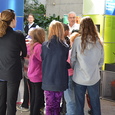 This image shows an NWMO employee speaking with students at the Elliot Lake open house in April.