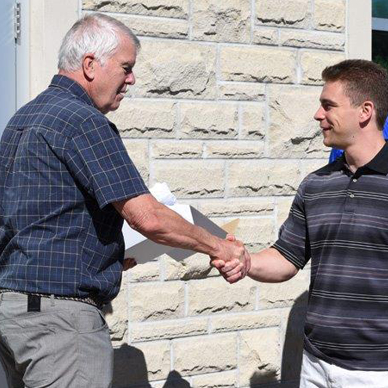 Dr. Stewart McIntyre presents Joseph Turnbull with his prize.