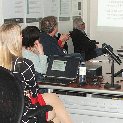 Blind River CLC members sit and listen to a presentation given by Michelle Dassinger of the NWMO exploring the new website.