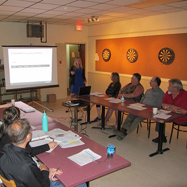 Michelle Dassinger, Digital Communications Program Manager, explores the new website with the Hornepayne Nuclear Waste Community Liaison Committee.