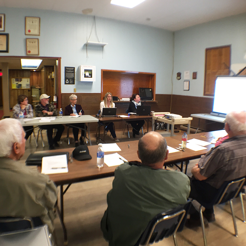 Michelle Dassinger, Digital Communications Program Manager, explores the new website with the White River Community Liaison Committee.