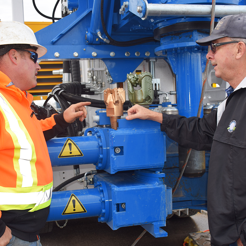 This picture shows a visitor looking at different drill bits in front of a drill rig during an open house held in Huron-Kinloss in November.
