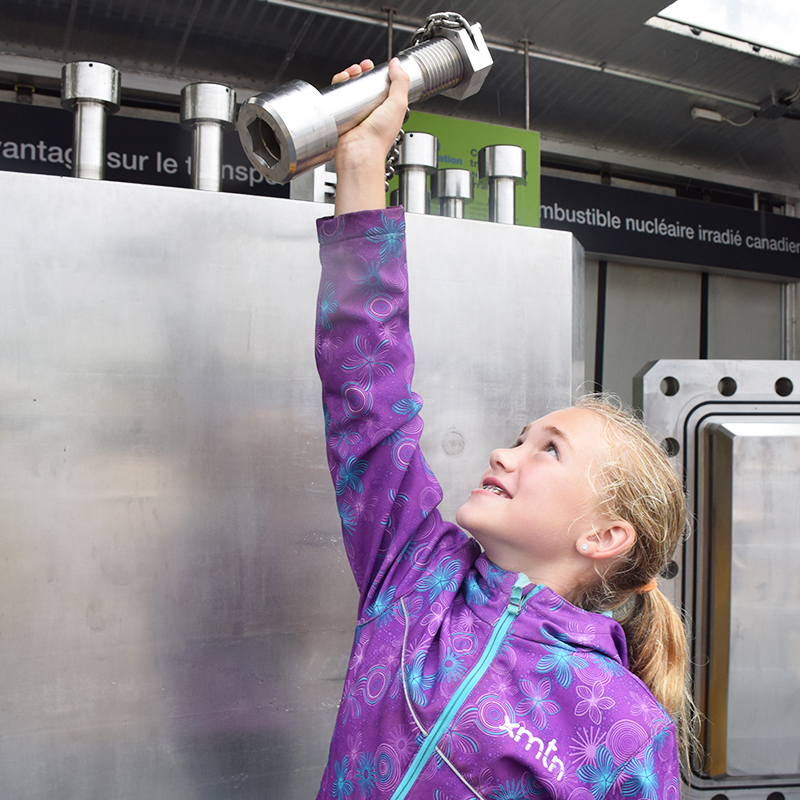 This photo depicts a child checking out the Used Fuel Transportation Package exhibit at the Lucknow Fall Fair held in September.