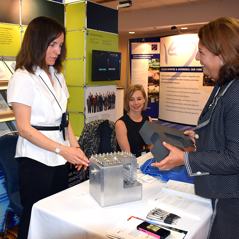An attendee visits the NWMO booth at the Canadian Nuclear Society Conference on Nuclear Waste Management, Decommissioning and Environmental Restoration.