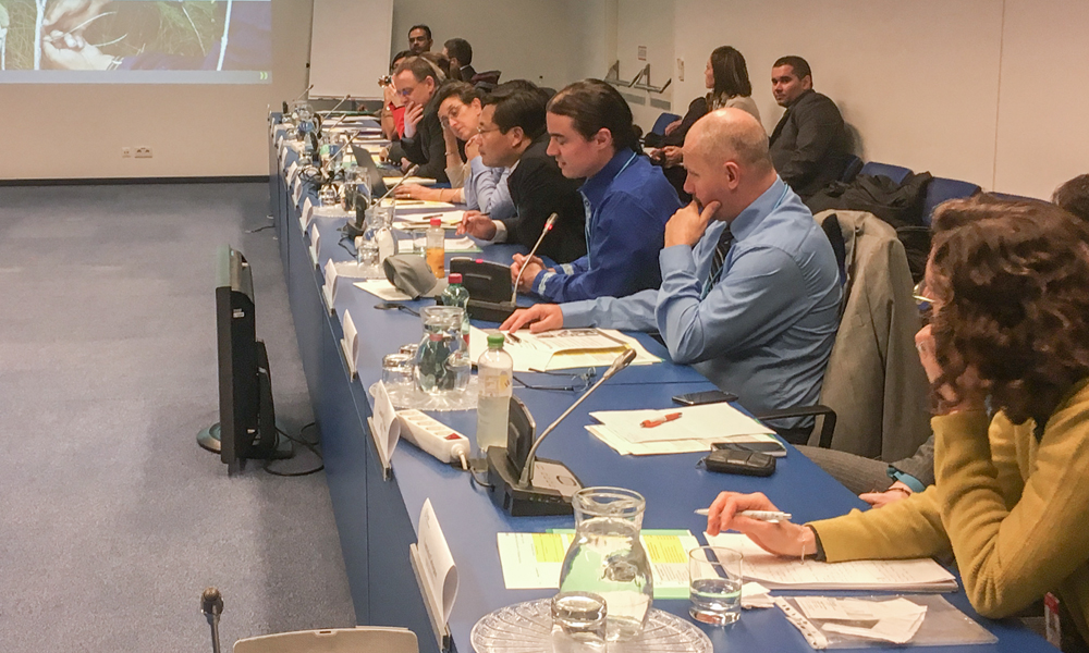 This image shows international representatives at a large table.