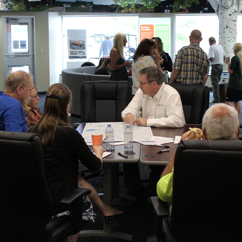 Groups of area residents speaking with NWMO  staff in Ignace Learn More Centre.