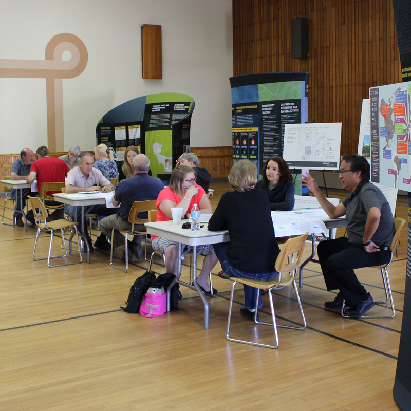 NWMO Staff and Manitouwadge residents study maps at open house.