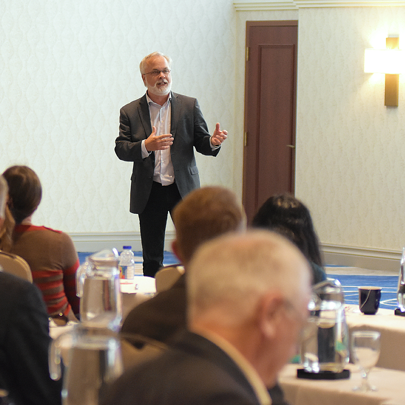 NWMO's director of deep geological repository geoscience and research, Mark Jensen, speaking to a room. 