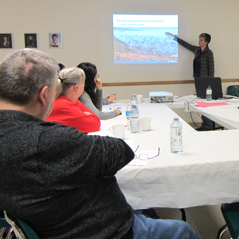 This image shows people watching a presentation 