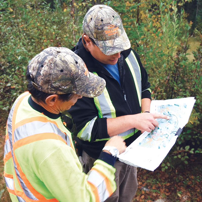 This image shows two people pointing to a document