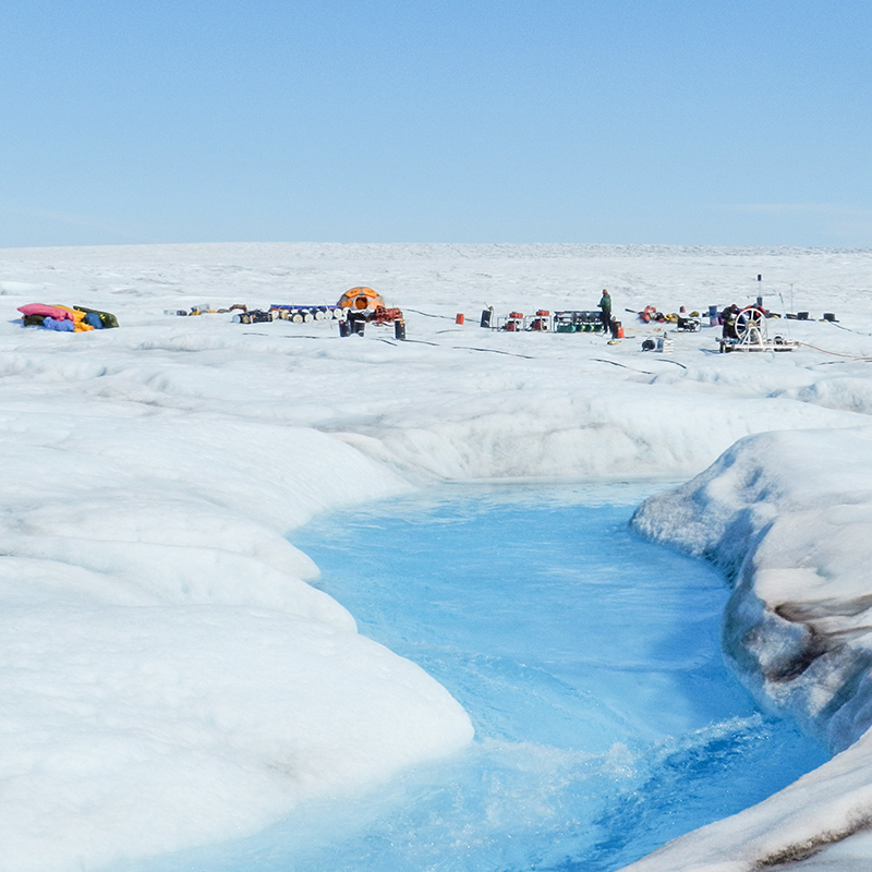 The photo shows a group of researchers’’ tents on the Greenland Ice Sheet.