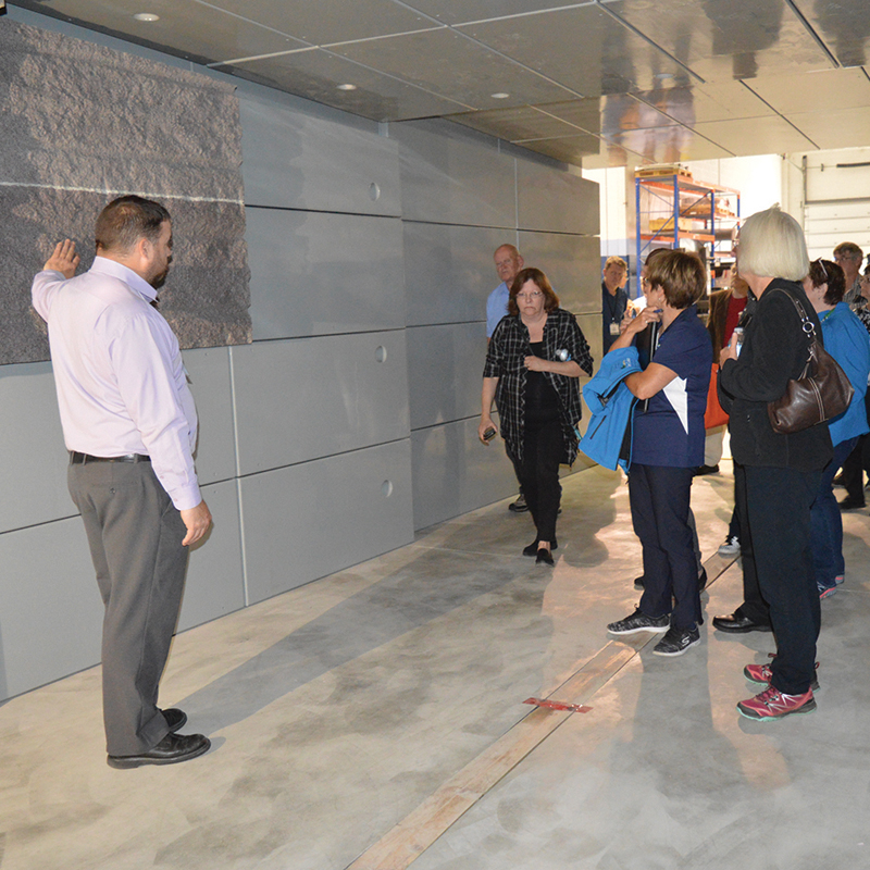 The photo shows a group of councillors from Elliot Lake, Blind River and area touring a model of a placement room for used nuclear fuel at the NWMO’s Oakville Proof Test Facility.