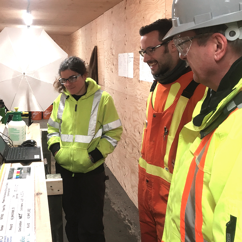 Three NWMO staff members at the borehole drilling site