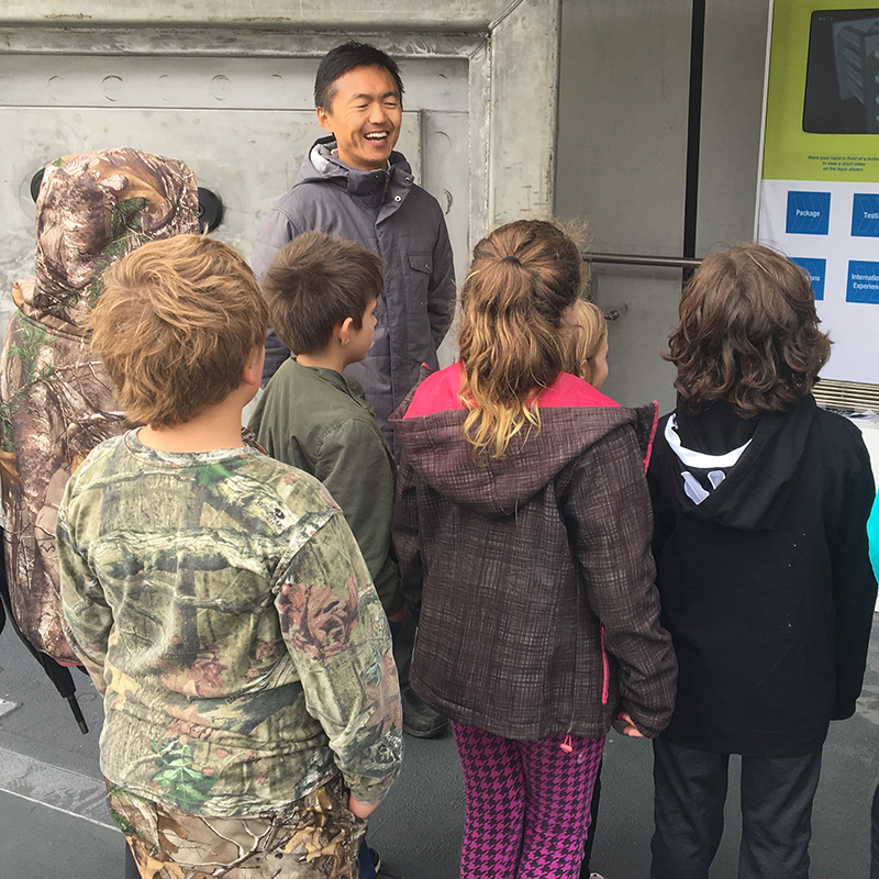  Yang Sui, NWMO Mechanical Engineer, talking with elementary school students.