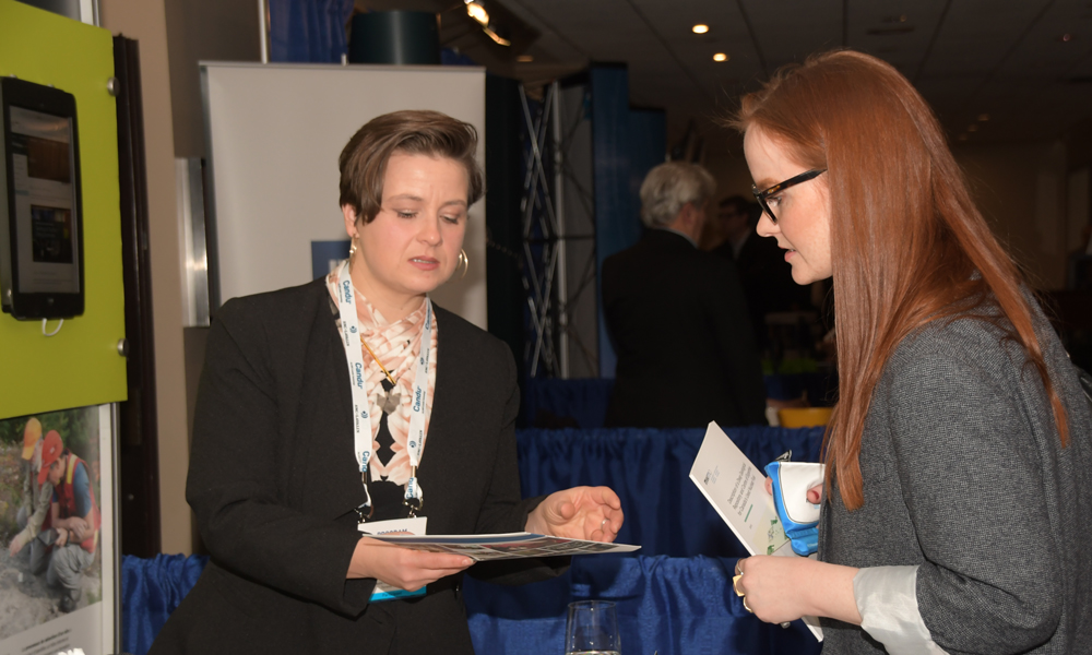 Image shows CNA2018 conference visitors gathered at the NWMO booth.