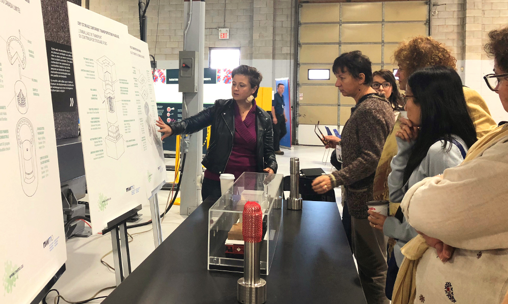 This image shows people looking at information on a poster board.