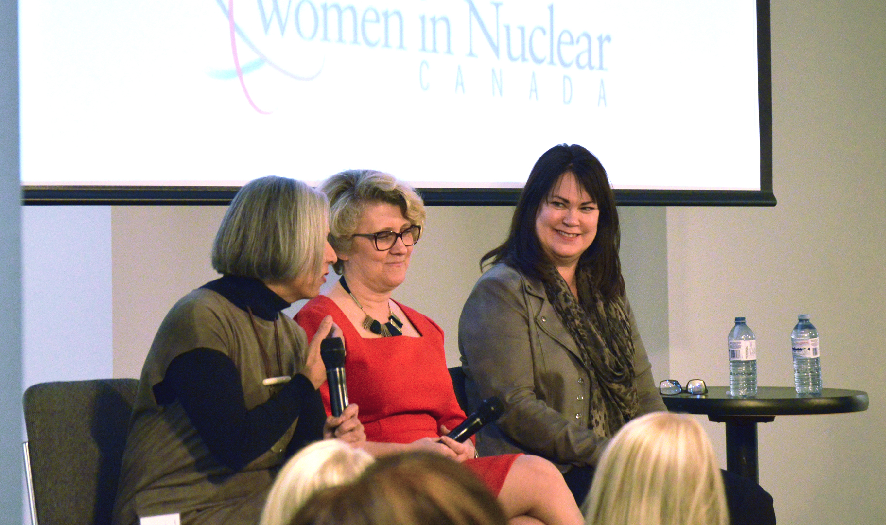 This image shows Rumina Velshi, Laurie Swami and Carla Carmichael sitting in a row.