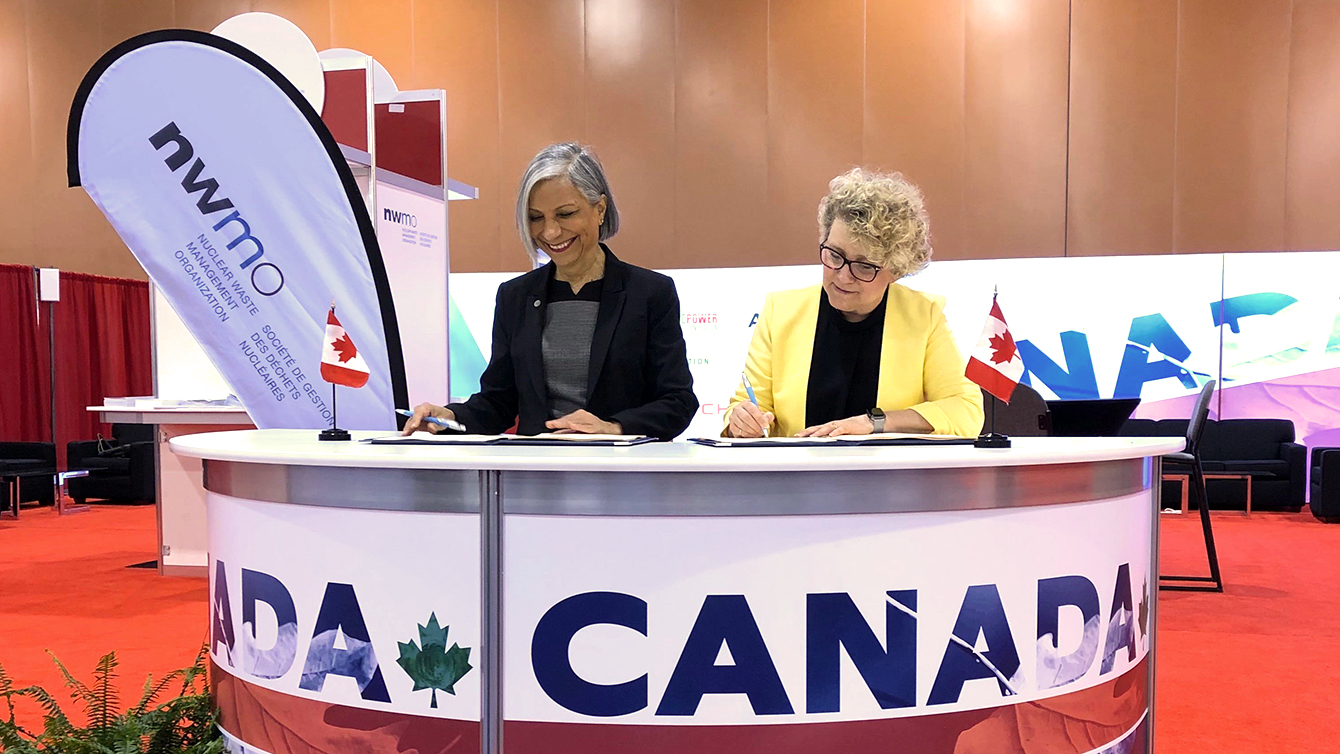 This is a photo of NWMO President and CEO Laurie Swami, together with Rumina Velshi, President and Chief Executive Officer of the Canadian Nuclear Safety Commission, signing a service agreement recommitting to a positive and constructive working relationship. 