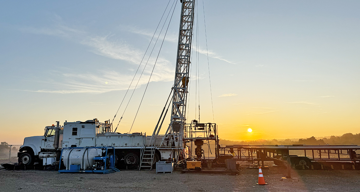 A truck-mounted service rig at a borehole site near Teeswater, Ont., during sunset.