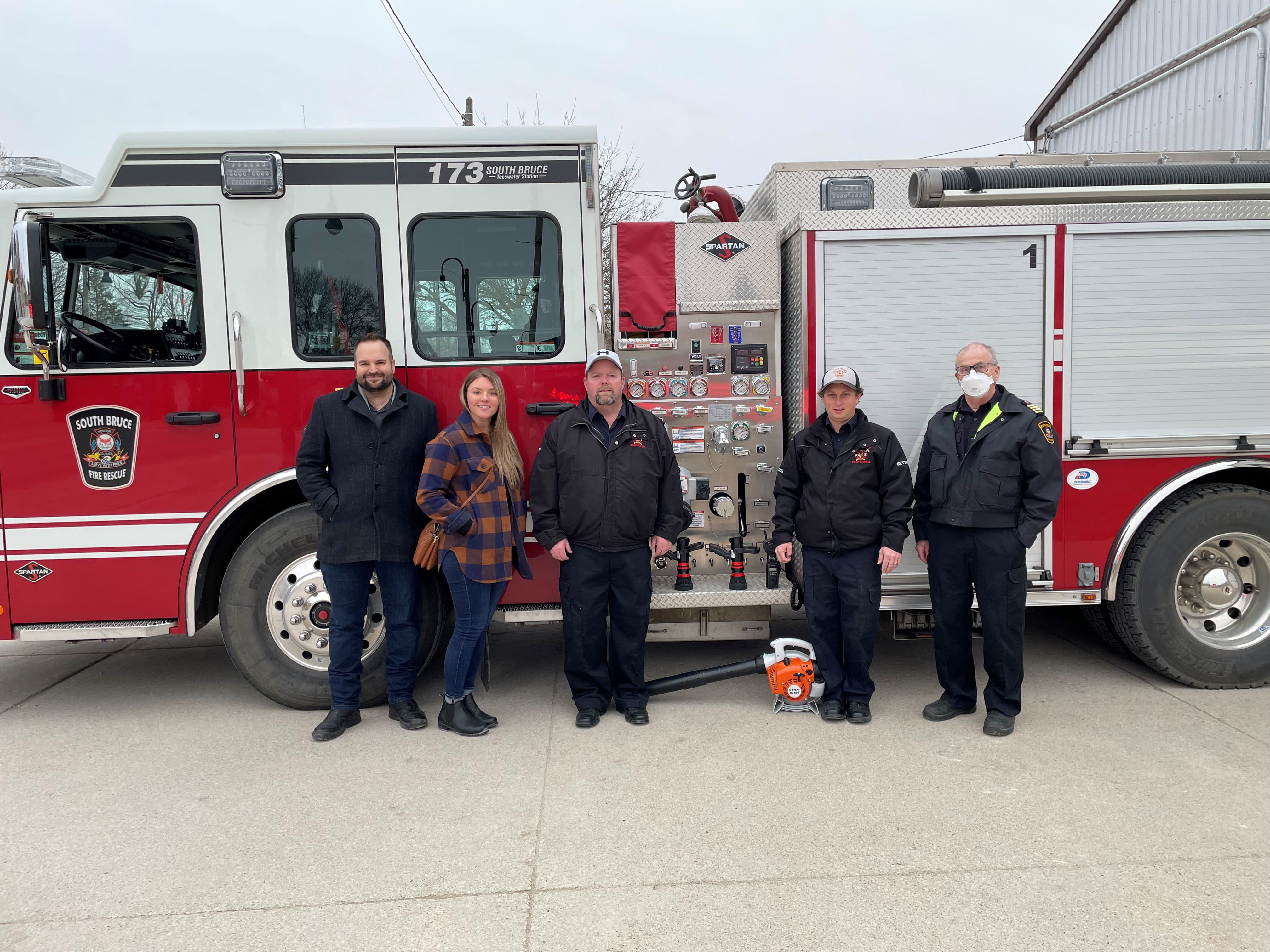 Firefighters and other employees standing in front of firefighters. Firefighters and other employees standing in front of firefighters.