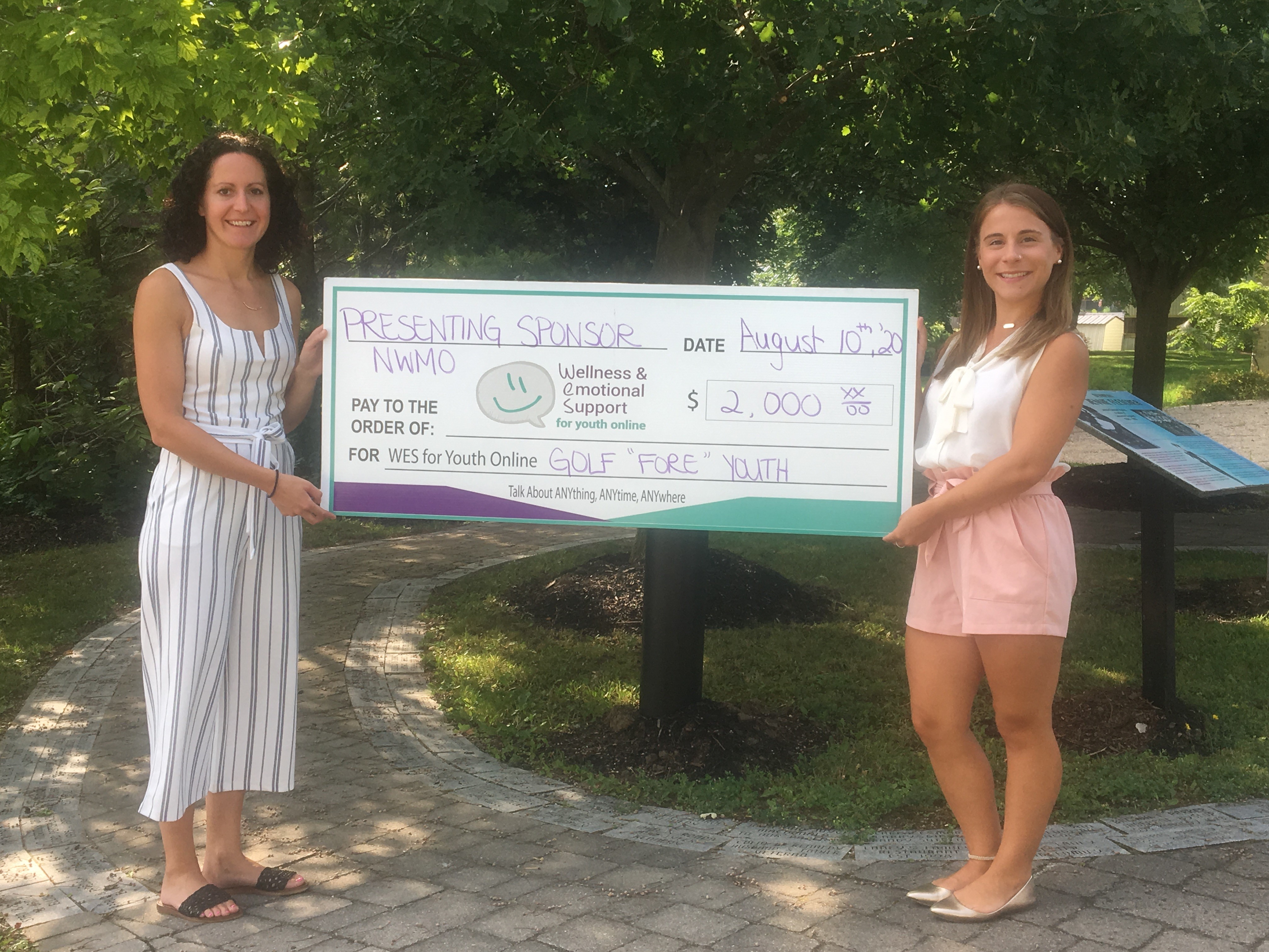 NWMO employee presenting WES for Youth a cheque