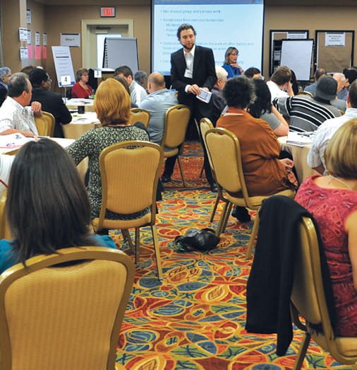 An image of a person talking with a group of people.