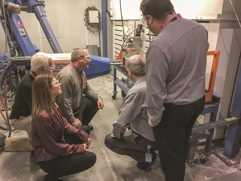 Scientists from the NWMO and Western University visit a national research facility where coatings are made and applied to prototype used fuel containers.