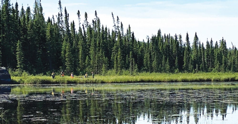 A photo of a environmental studies team on a waterfront.