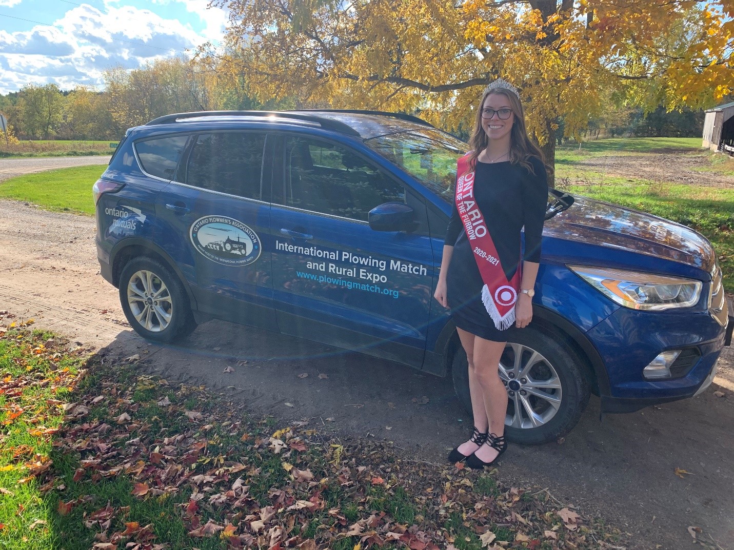 Anna Lennox in front of a car.