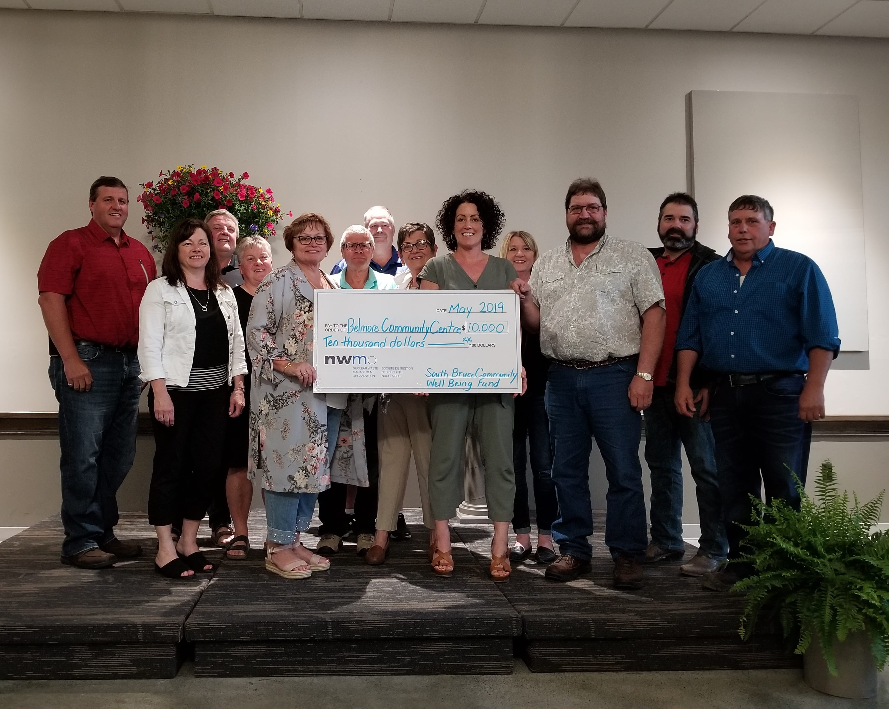 Members of the Belmore Community Centre Renovation Committee celebrate the reopening of the hall with members of the South Bruce Council and the Nuclear Waste Management Organization.