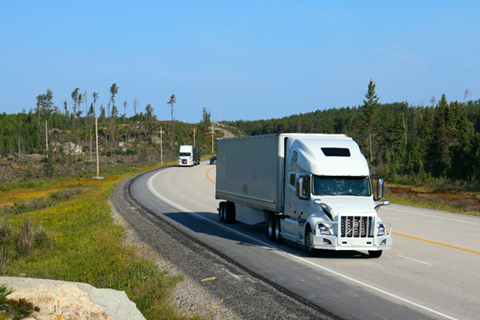 A semi truck driving down the road A semi truck driving down the road