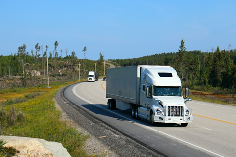 A semi truck driving down the road