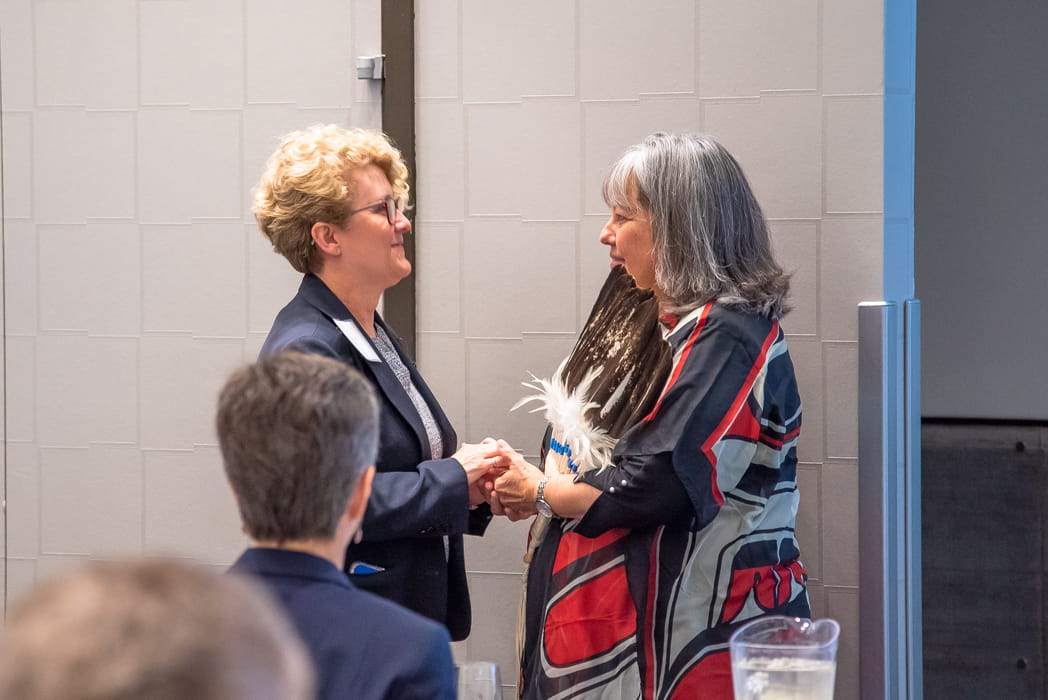 NWMO President and CEO Laurie Swami (left) and Elder Diane Longboat (right) greet each other at the NWMO’s 17th annual Geoscience Seminar.