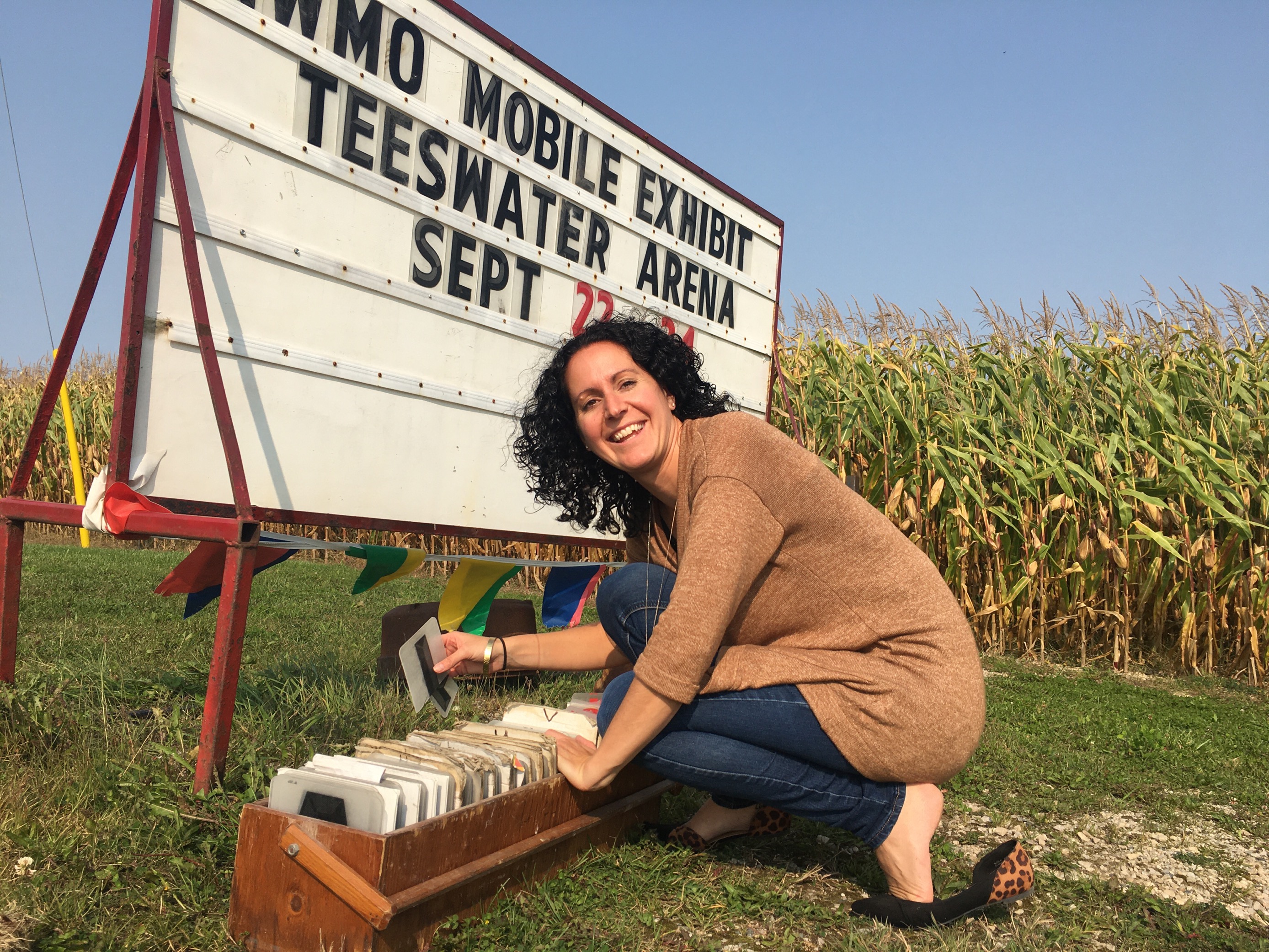 Woman putting up billboard sign