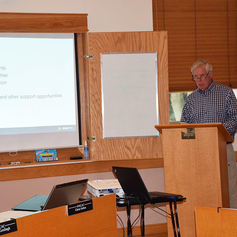 This photo depicts AECOM consultant Andy Keir giving a presentation about Community- Well at the June Huron-Kinloss Nuclear Waste Community Advisory Committee meeting.