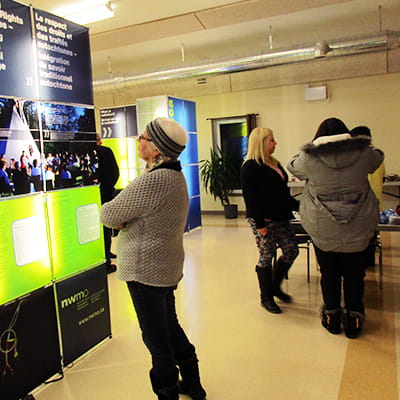 A woman looks at the open house module on interweaving Aboriginal Traditional Knowledge.