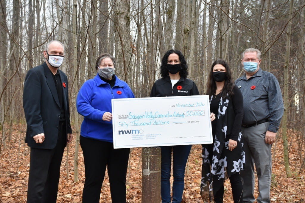 People holding a cheque  