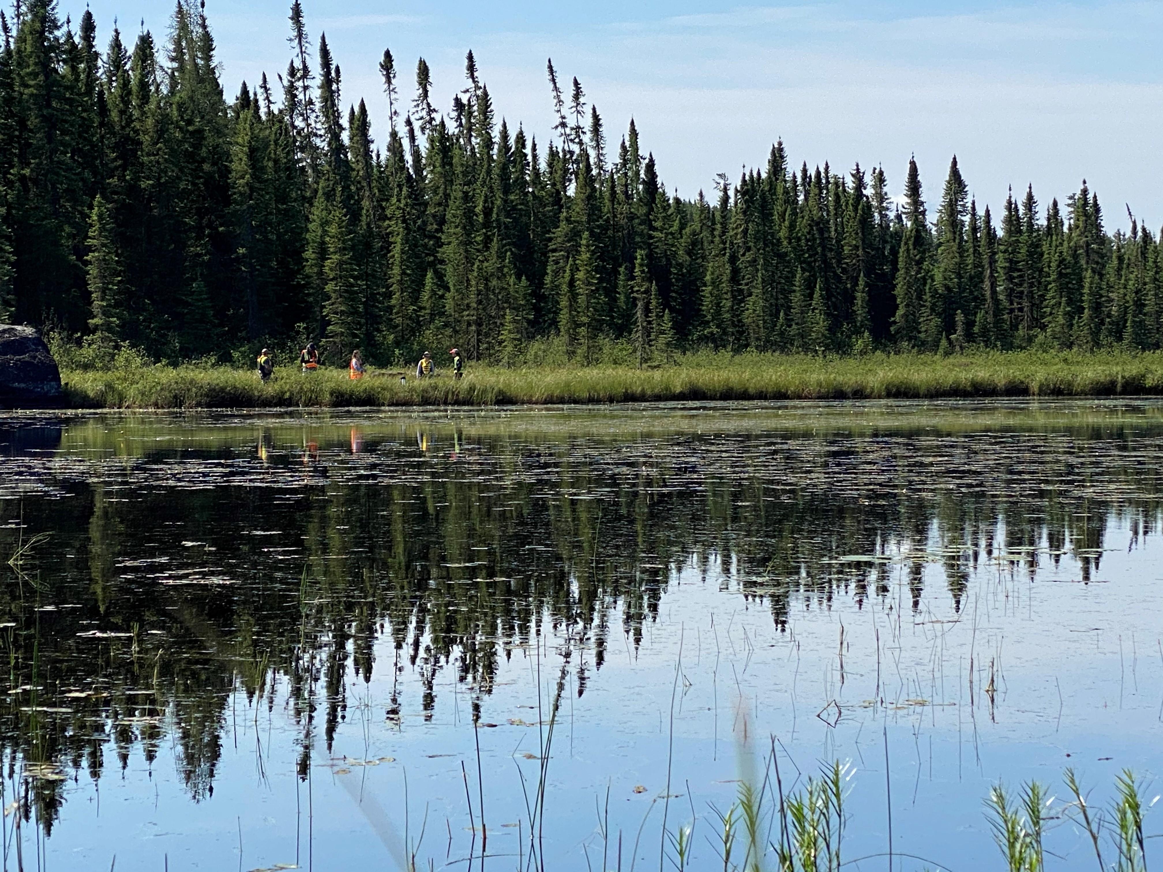 Field team along the shore of a lake.