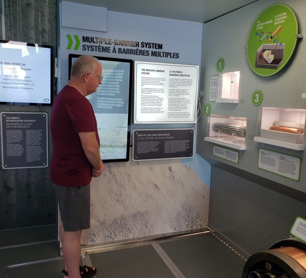 a person reviews the NWMO mobile Learn More Centre